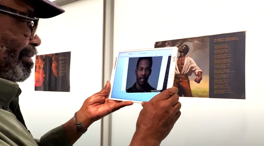 Berkeley researcher Cecil Brown models the use of an iPad on his augmented reality project that recreates the voice and image of Black slave poet George Moses Horton.